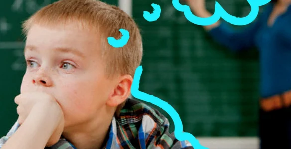 Menino distraído em sala de aula, com desenho de balão de pensamento azul representando sua imaginação.