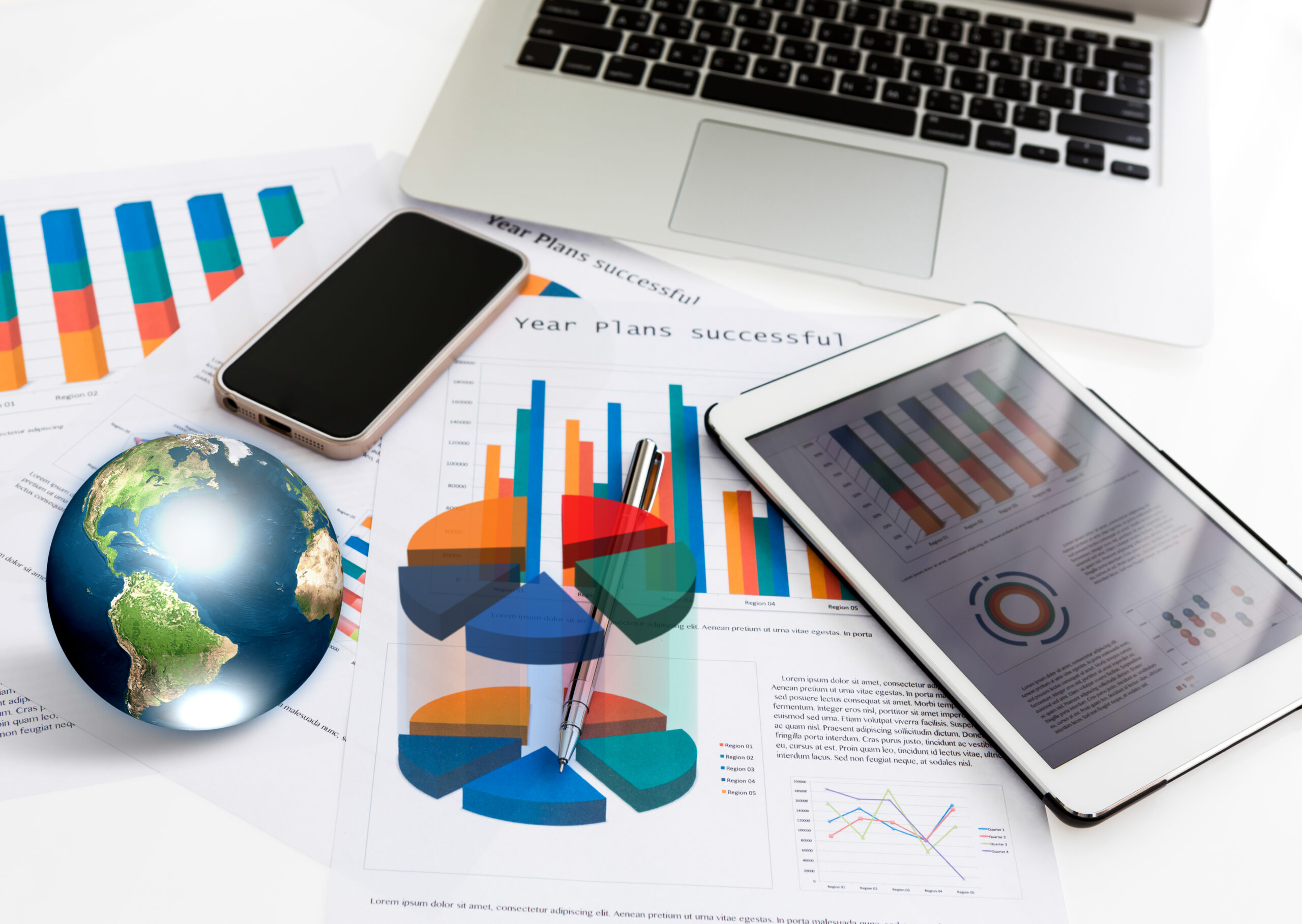 Financial charts on the table with tablet phone and pen (Elemen