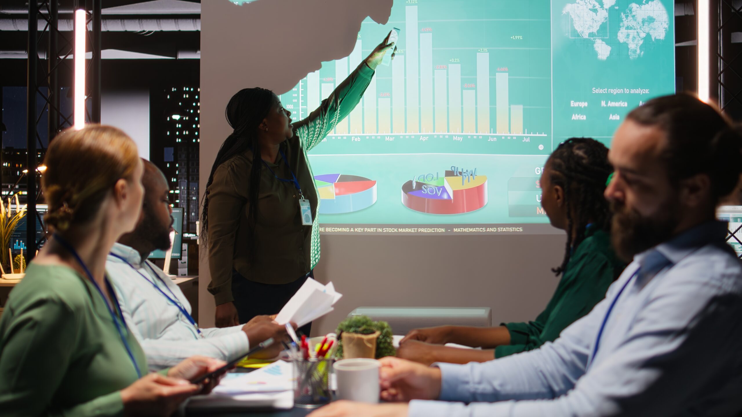 Diverse group of corporate associates look into project timelines and agenda