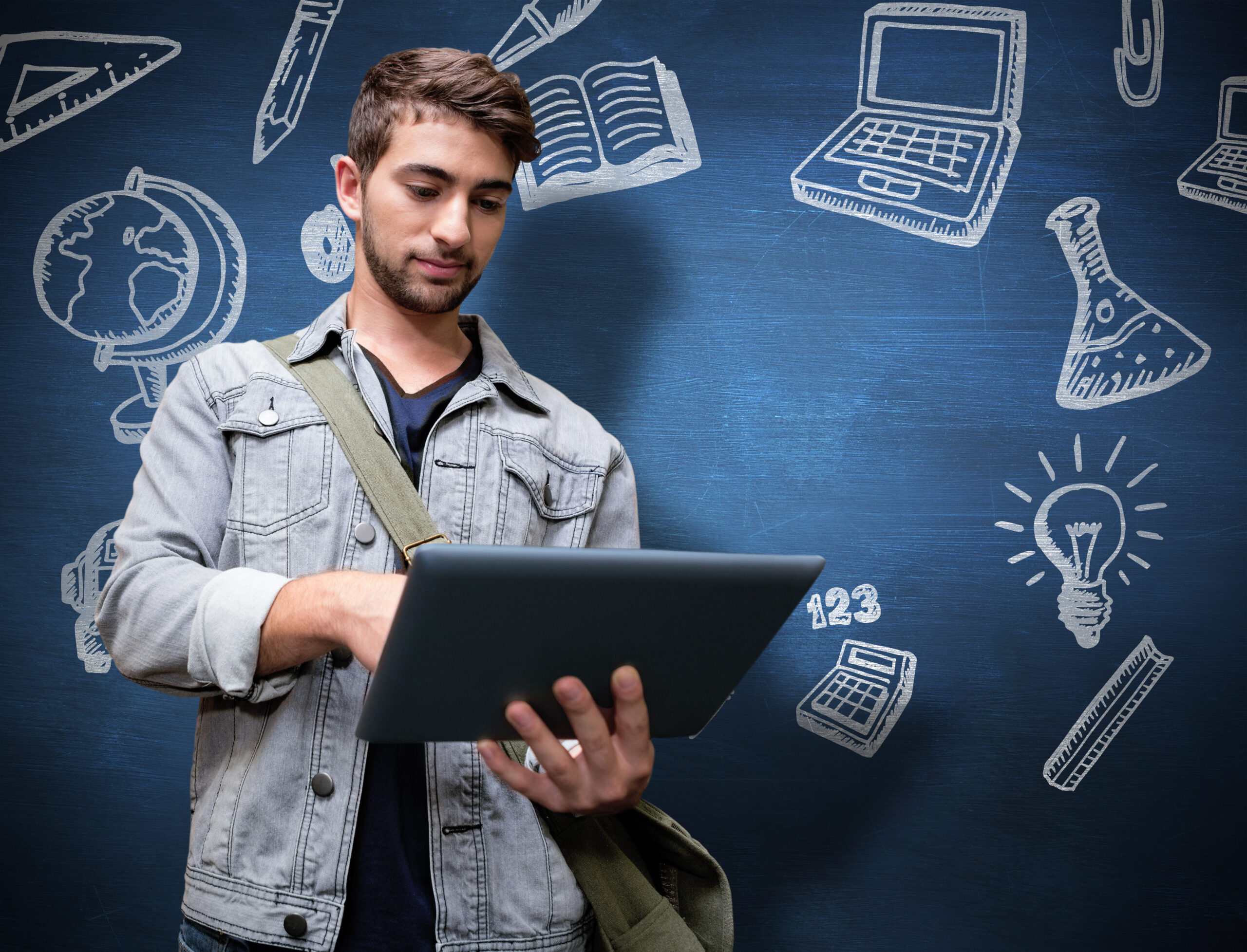 Student using tablet in library against blue chalkboard