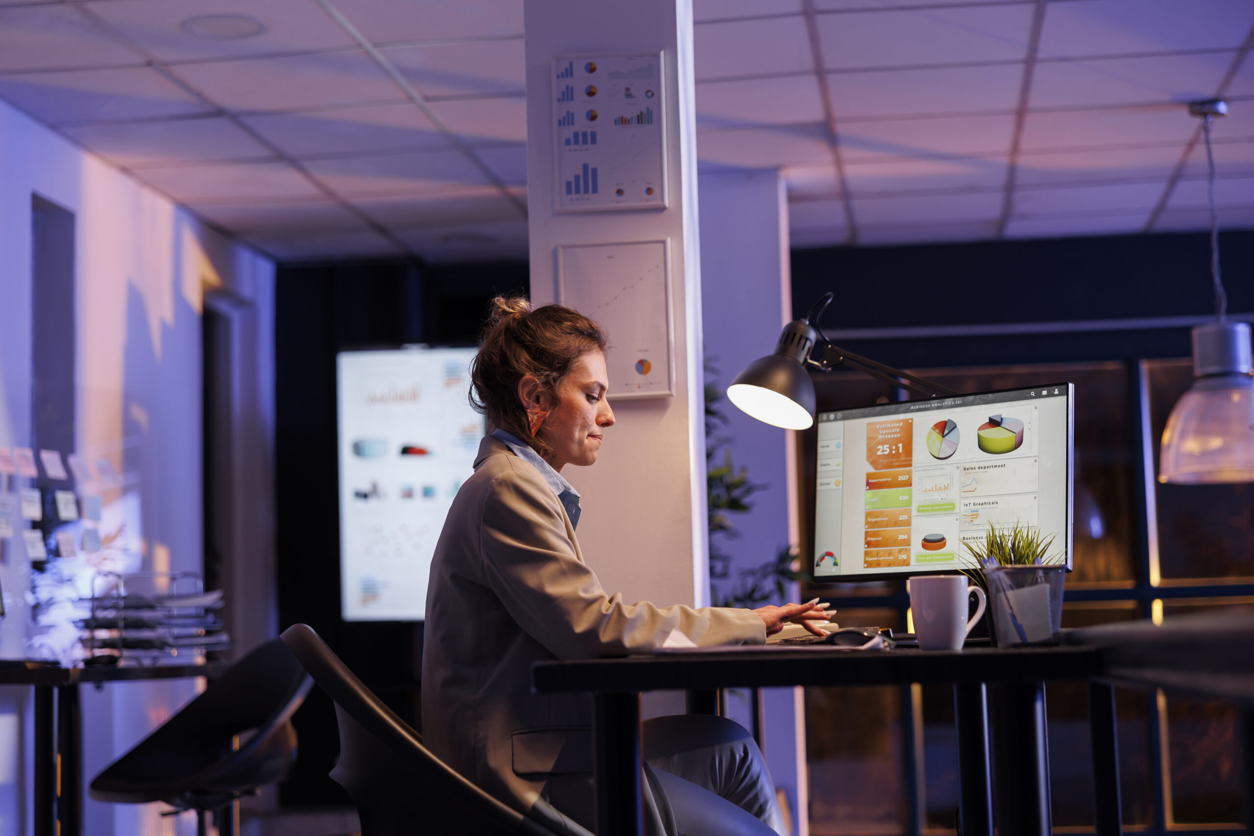 Businesswoman typing company strategy on computer