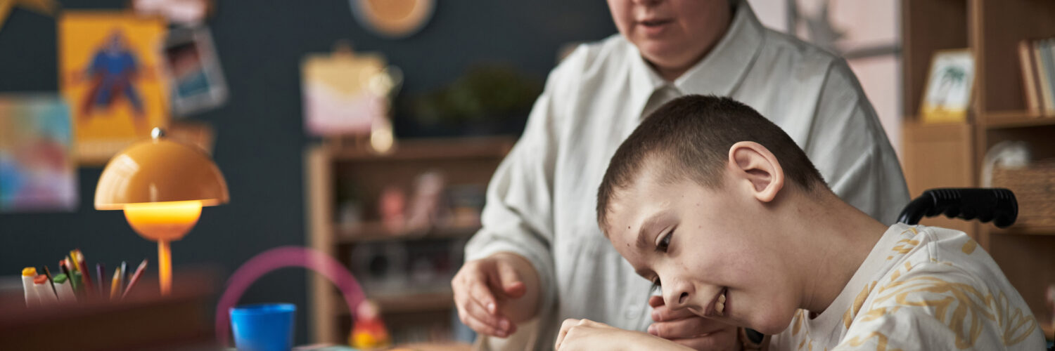 Child with Disability Learning with Teacher in Classroom Environment