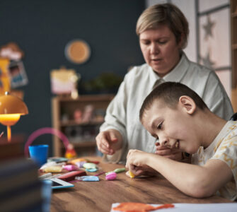 Child with Disability Learning with Teacher in Classroom Environment