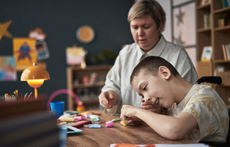 Child with Disability Learning with Teacher in Classroom Environment