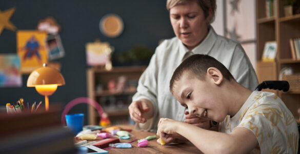 Child with Disability Learning with Teacher in Classroom Environment