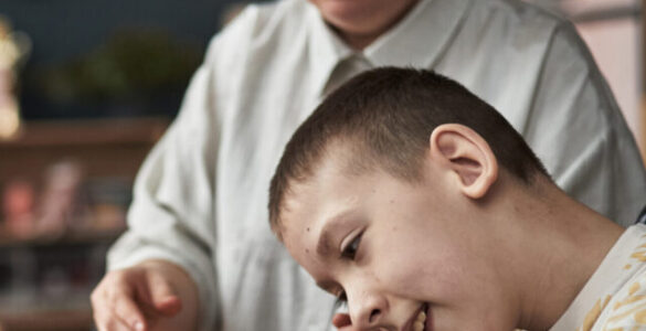 Child with Disability Learning with Teacher in Classroom Environment
