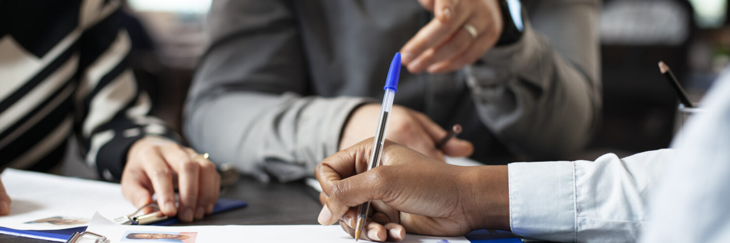 Black person signing job contract