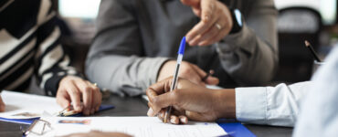 Black person signing job contract