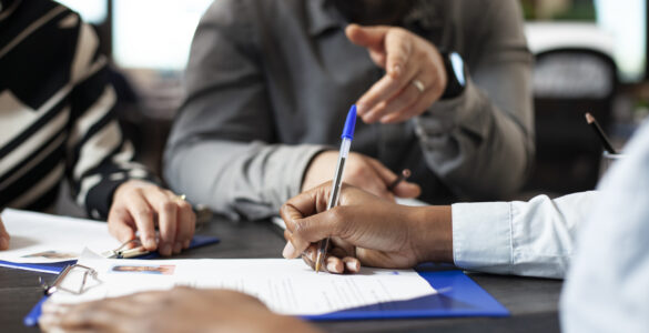 Black person signing job contract