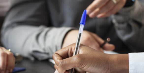 Black person signing job contract